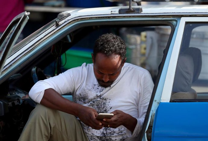 Un ciudadano etíope consulta su teléfono móvil  en la capital del país, Addis Ababa.