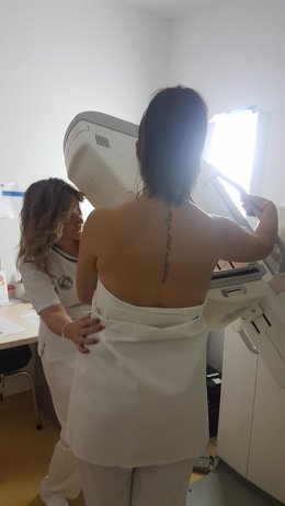 Realización de una mamografía a una mujer.