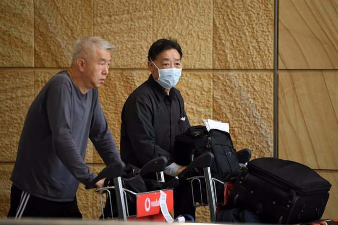 A passenger wearing a protective masks on arrival at Sydney International Airport in Sydney, Thursday, January 23, 2020. Australia is working to keep out the deadly coronavirus, as a flight from the city at the centre of the outbreak arrives in Sydney. 