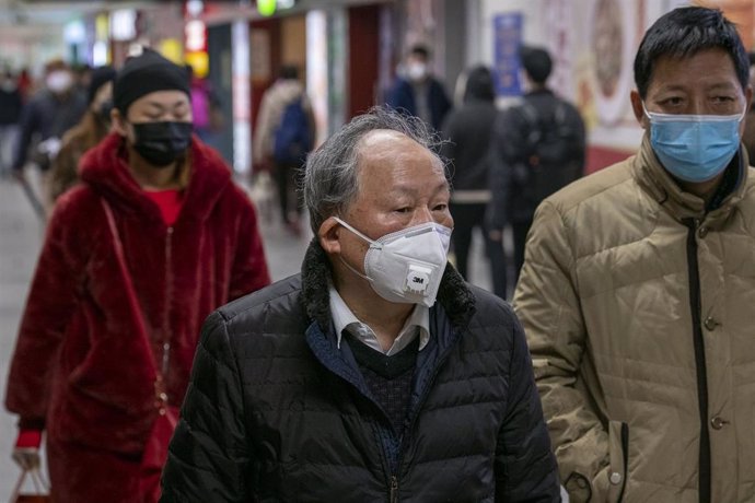 January 24, 2020 - Shanghai, China: Chinese Lunar New Year travellers at South Shanghai Railway Station wear protective face masks in wake of the coronavirus outbreak.