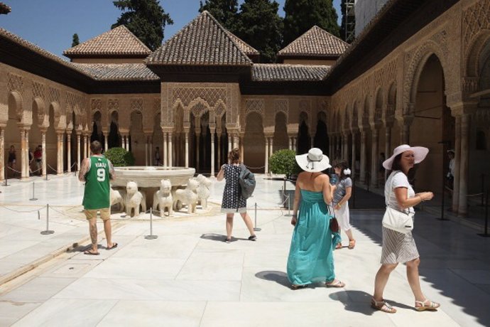GRANADA, SPAIN - JULY 20:  Visitors walk through the Patio of the Lions in the Nasrid Palaces at the Alhambra on July 23, 2013 in Granada, Spain. Southern Spain is among Europe's biggest tourist destinations.  (Photo by Sean Gallup/Getty Images)