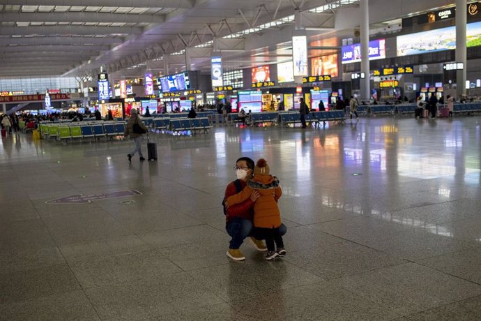January 27, 2019 - Shanghai, China: A man and his young daughter at Hongqiao Raliaway Station wear protective face masks in wake of the coronavirus outbreak. The station was unusually quiet as many residents stayed indoors to avoid contracting the virus