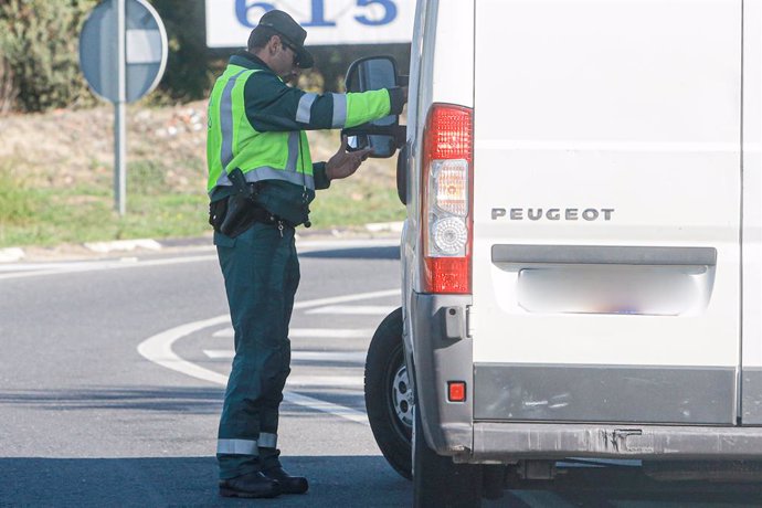 Un agente de la Guardia Civil de Tráfico pide la documentación a una furgoneta 