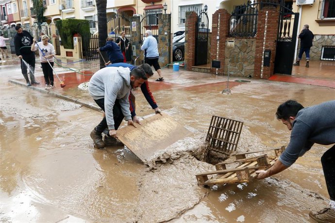 Vecinos de la barriada malagueña de Campanillas, se afanan en las limpiezas de sus hogares y calles del barrio tras la tromba de aguda caída esta pasada madrugada a consecuencia de la Tormenta Gloria que azota al país. En Málaga a 25 de enero del 2020