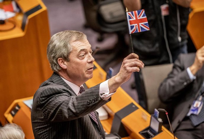 29 January 2020, Belgium, Brussels: Brexit party leader Nigel Farage waves a small Britain flag during a plenary session of the European Parliament, two days before losing his mandate on 31 January 2020 when Brexit comes into force. 