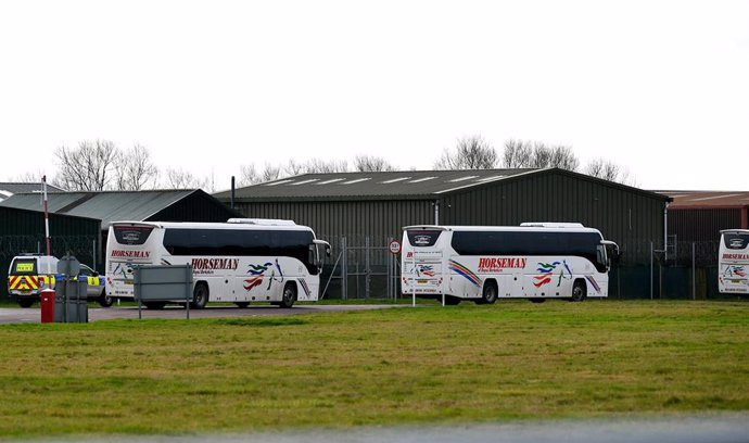 31 January 2020, England, Brize Norton: Coaches enter RAF Brize Norton in Oxfordshire, where a plane carrying British nationals from the coronavirus-hit city of Wuhan in China, is due to arrive on Friday. Britain has confirmed its first cases of the cor