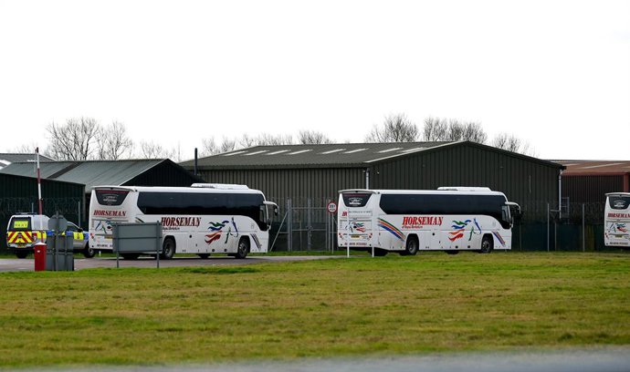 31 January 2020, England, Brize Norton: Coaches enter RAF Brize Norton in Oxfordshire, where a plane carrying British nationals from the coronavirus-hit city of Wuhan in China, is due to arrive on Friday. Britain has confirmed its first cases of the cor
