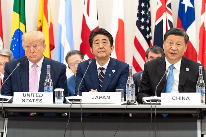 June 28, 2019 - Osaka, Japan: President Donald J. Trump, seated next to Japanese Prime Minister Shinzo Abe, listens as Chinas President Xi Jinping, right, delivers remarks at the G20 Leaders Special Event on the Digital Economy at the G20 Japan Summit