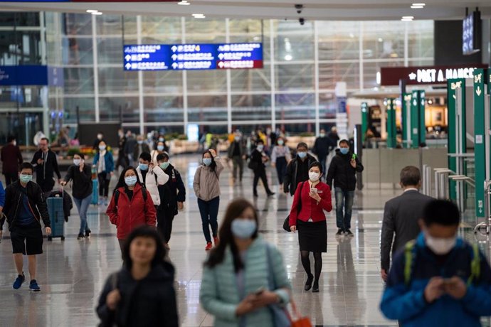 Travellers and airline crew members are seen wearing surgical masks as a protective measure from the deadly coronavirus at the Hong Kong international airport. 