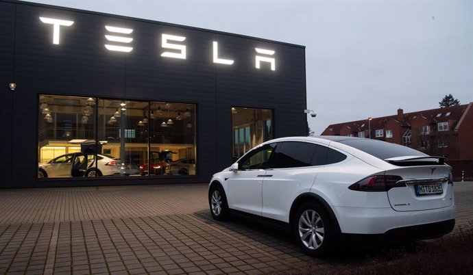 Imagen de un Tesla Model X delante de un concesionario. 