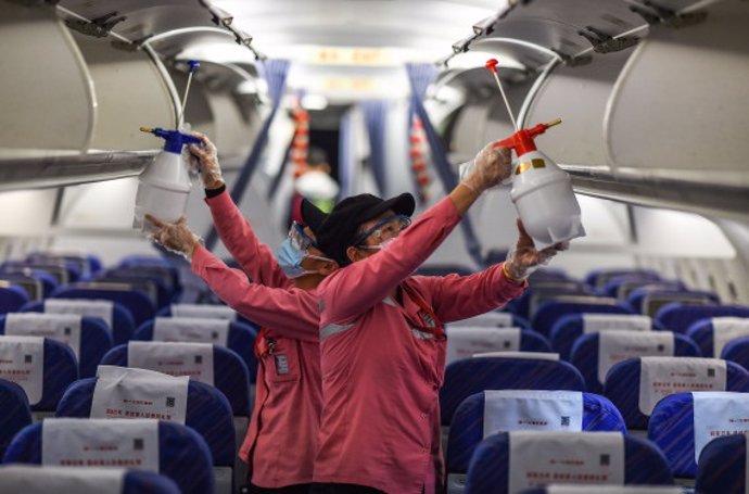 Empleados desinfectan la cabina de un avión después de su llegada al Aeropuerto Internacional de Haikou Meilan, provincia de Hainan, en el sur de China. 31 de enero de 2020.