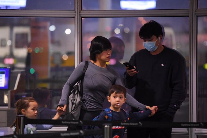 Australian evacuees who were quarantined on Christmas Island over concerns about the COVID-19 coronavirus arrive at Sydney Airport in Sydney, Monday, February 17, 2020. The bulk of the people quarantined on Christmas Island have been flown to the mainla