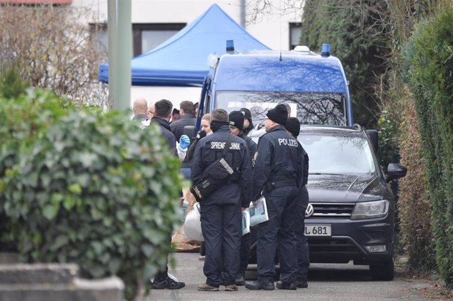 20 February 2020, Hessen, Hanau: German police officers stand near the house where the suspected perpetrator was found dead.  At least nine people were killed and others injured when shots were fired at two shisha bars in Hanau. Photo: Boris Roessler/dpa
