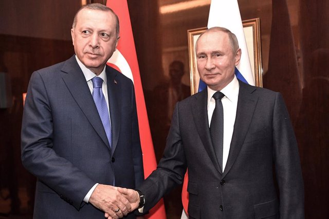 FILED - 19 January 2020, Berlin: Turkish President Recep Tayyip Erdogan (L) shakes hands with Russian President Vladimir Putin, during their meeting on the sidelines of the Berlin's International Peace conference on Libya. Turkey will decide on its next s