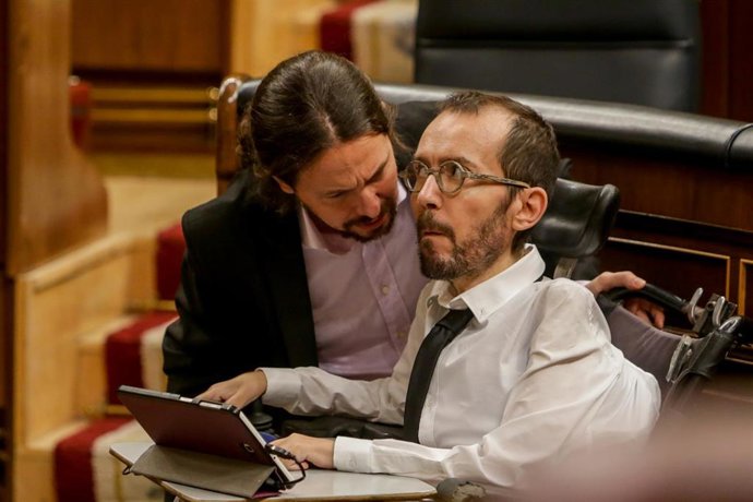 El vicepresidente segundo y ministro de Derechos Sociales y Agenda 2030, Pablo Iglesias (i), habla con el portavoz de Unidas Podemos en el Congreso de los Diputados, Pablo Echenique (d)