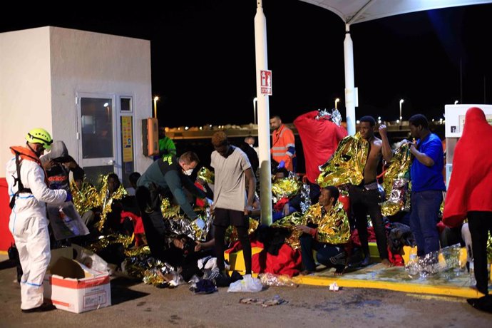 Inmigranes procedentes de una patera a la deriva al puerto de Melilla siendo atendido por voluntarios de la Cruz Roja en Melilla  a 27 de noviembre 2019 (Foto de archivo).