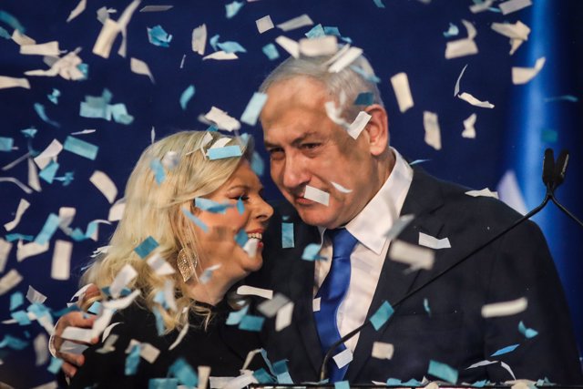 03 March 2020, Israel, Tel Aviv: Israeli Prime Minister and Chairman of the Likud Party, Benjamin Netanyahu, embraces his wife Sara as he addresses supporters following early exit polls. Photo: Ilia Yefimovich/dpa
