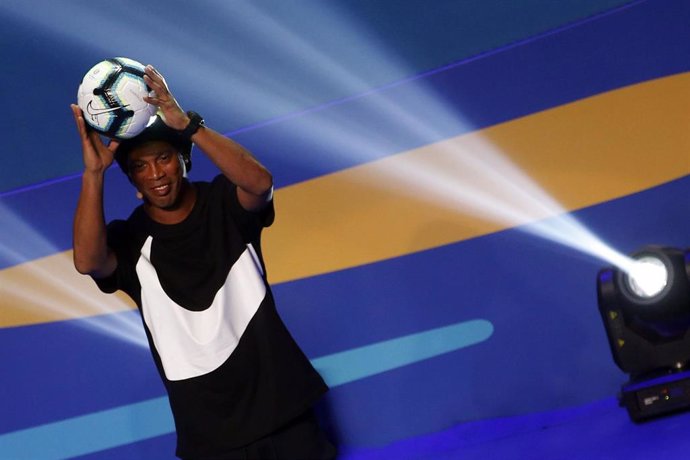 Ronaldinho lifts a ball during a ceremony to draw the three groups of the upcoming 2019 Copa America
