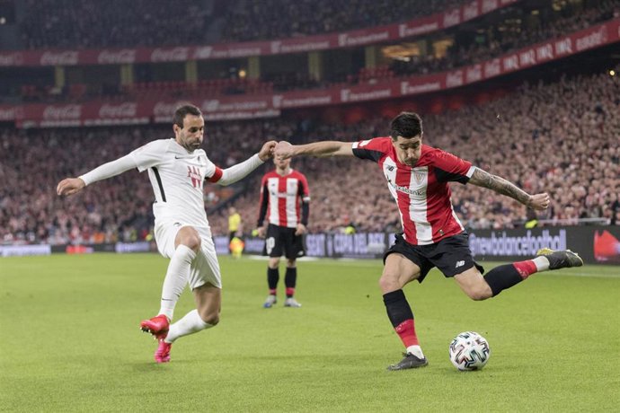 12 February 2020, Spain, Bilbao: Athletic Bilbao's Yuri Berchiche (R) and Granada's Victor Diaz Miguel battle for the ball during the Copa del Rey semi final soccer match. Photo: Edu Del Fresno/ZUMA Wire/dpa
