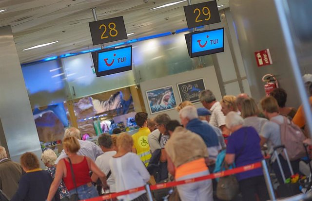 Varios turistas en el aeropuerto hacen cola en el mostrador de la compañía aérea TUI después de abandonar el Hotel H10 Costa Adeje Palace tras más de una semana en cuarentena por el brote de coronavirus de la isla de Tenerife, en Adeje/Tenerife/Islas Cana
