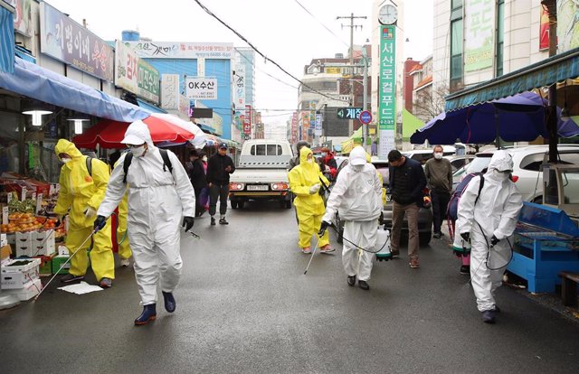 Equipos de desinfección trabajan en las labores de limpieza de un mercado al aire libre en las calles de Seosan, en el oeste de Corea del Sur.