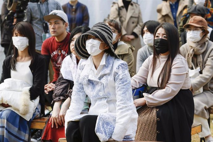 11 March 2020, Japan, Tokyo: People wear face masks to prevent the spread of the coronavirus as they attend a memorial ceremony at Hibiya Park to mark the ninth anniversary of 2011 Tohoku earthquake and tsunami. Photo: Rodrigo Reyes Marin/ZUMA Wire/dpa