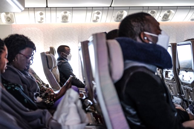 11 March 2020, Senegal, Dakar: Passengers with face masks sit inside an air plane, amid the outbreak of the Coronavirus. Photo: Sadak Souici/Le Pictorium Agency via ZUMA/dpa
