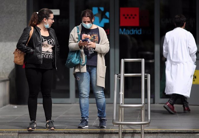 Dos mujeres protegidas con mascarilla a las afueras del Hospital de la Paz donde se ha habilitado un espacio para atender "en mejores condiciones" a pacientes sospechosos de coronavirus, en Madrid (España), a 12 de marzo de 2020.