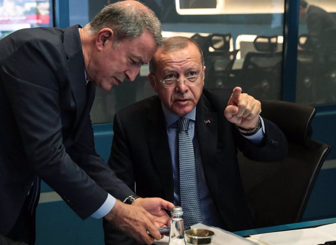 El presidente de Turquía (sentado) y el ministro de Defensa (de pie), Recep Tayyip Erdogan y Hulusi Akar, respectivamente