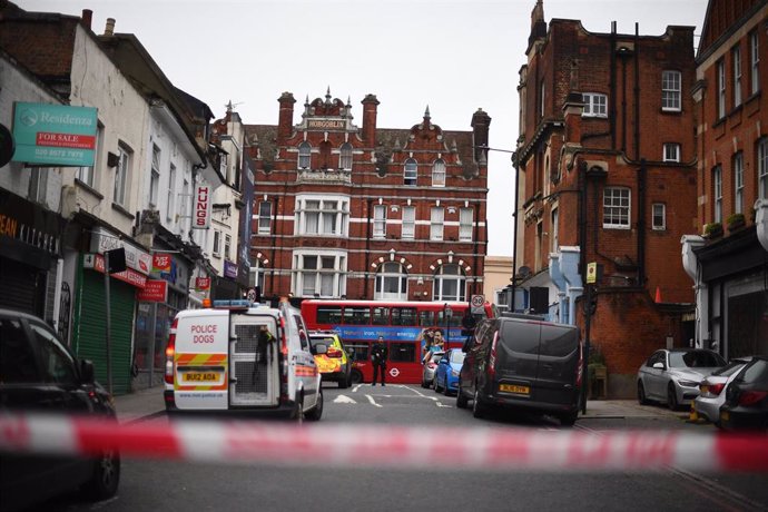 02 February 2020, England, London: Police seen behind  a caution tape at the scene, where a man has been shot dead by police after he stabbed several people in the south London suburb of Streatham. The incident has been declared as "terrorist-related" b