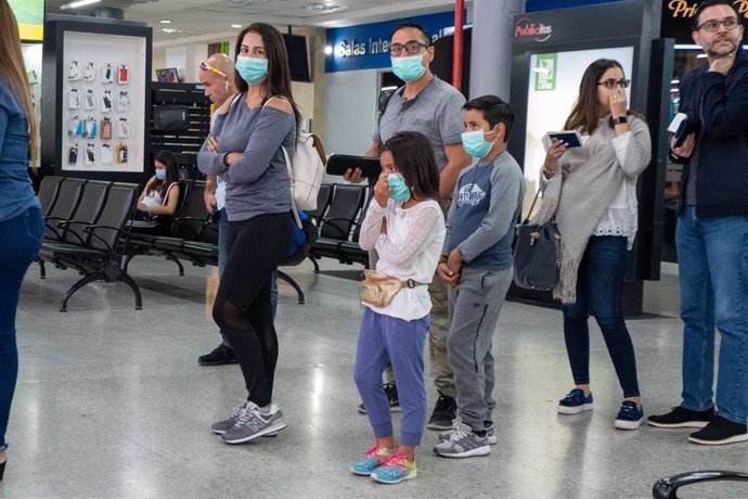 Imagen de pasajeros con mascarillas en un aeropuerto de Honduras. 