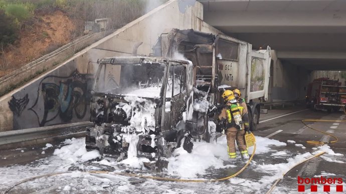 Efectivos de Bombers de la Generalitat apagan un fuego en la cabina de un camión de basura en la GI-533, en Brunyola (Girona), el lunes 23 de marzo de 2020.