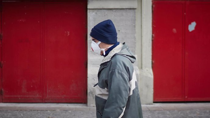 Una persona con mascarilla en la calle el día en el que entra en vigor la limitación total de movimientos salvo de los trabajadores de actividades esenciales