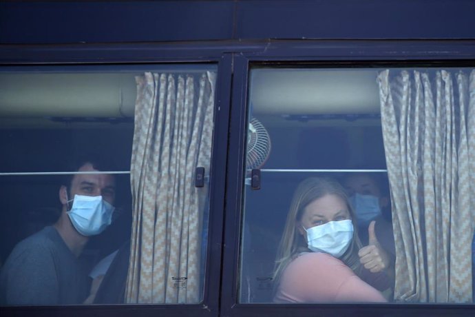 31 March 2020, Nepal, Kathmandu: American citizens wearing face masks wait at Tribhuvan International Airport for their flight to return to USA on the eighth day of Nepalese government imposed lockdown amid concerns over the coronavirus pandemic.  