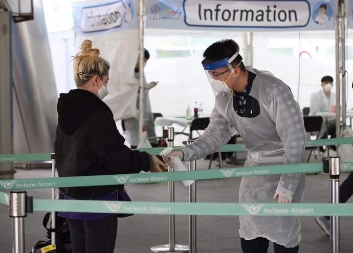 Una turista se somete al test del Covid-19 en un centro de pruebas ubicado temporalmente fuera de una terminal del Aeropuerto Internacional de Incheon, en el norte de Corea del Sur.