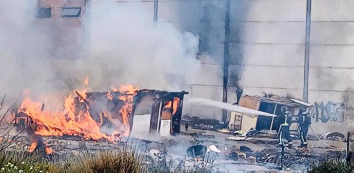 Intervención de los bomebros sodocando el fuego en el asentamiento chabolista abandonado