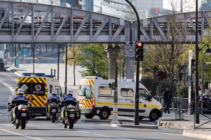 01 April 2020, France, Paris: Police escort two ambulances