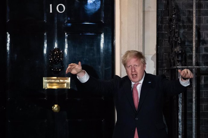 26 March 2020, England, London: UK Prime Minister Boris Johnson reacts outside 10 Downing Street as he takes part in the national applause for the NHS to show appreciation for all NHS workers who are helping to fight the Coronavirus. 