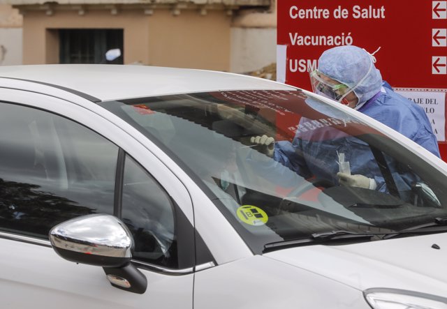 Una trabajadora sanitaria totalmente protegida perteneciente al Hospital de la Malvarrosa realiza un test de COVID-19  a un personal sanitario.