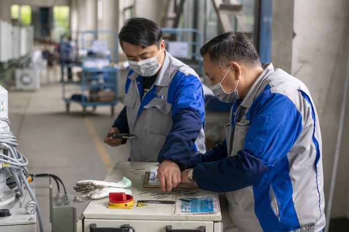 March 31, 2020 - Shanghai China: Workers wear face masks as a precaution against the ongoing Covid-19 outbreak at a factory operated by Buerkle. (Dave Tacon/Contacto)