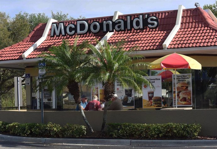 March 18, 2020 - Titusville, Florida, United States- Customers eat outdoors at a McDonald's in Titusville, Florida on March 18, 2020 as restaurants across the United States begin to temporarily close dining rooms in favor of carry-out and drive thru opt