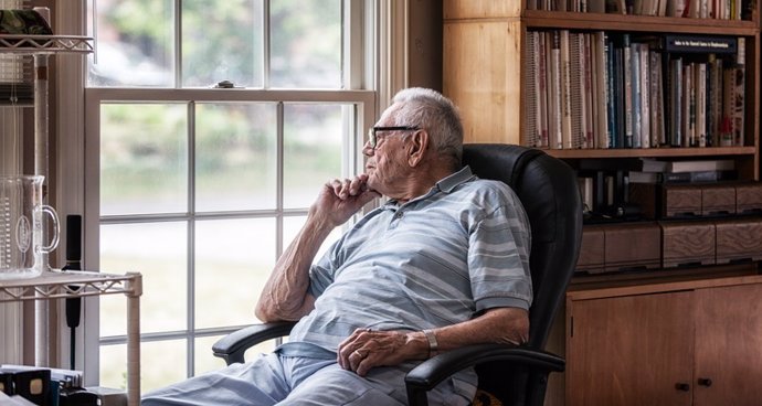 Day Dreaming Elderly Senior Man Staring Through Hazy Window