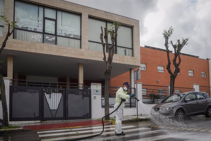 Personal del ayuntamiento desinfecta la zona del centro de personas mayores Joaquín Rosillo de San Juan de Aznalfarache (Sevilla), donde la Junta de Andalucía ha confirmado 79 casos de coronavirus Covid-19 y la muerte de 24 de los ancianos contagiados