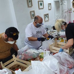 Voluntarios de Aspanoma preparan lotes de alimentos para familias de niños y niñas oncológicos de Málaga