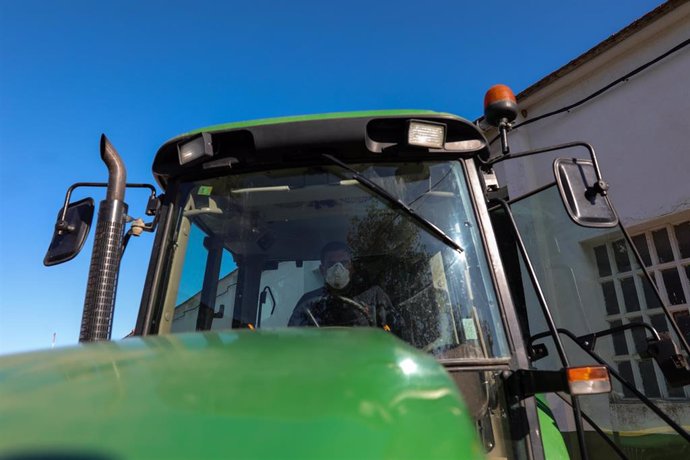 Un agricultor montado en su tractor