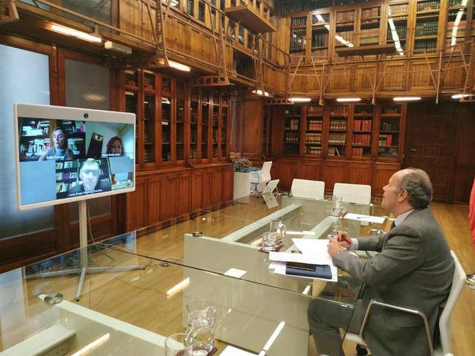 El ministro de Justicia, Juan Carlos Campo, en una reunión por videoconferencia con la decana del Colegio de Registradores, María Emilia Adán, y el presidente del Consejo General del Notariado, José Ángel Martínez Sanchiz, el 7 de abril de 2020.