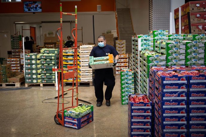 Un trabajador de Mercabarna transporta productos en cajas dentro del recinto, a 17 de abril de 2020.
