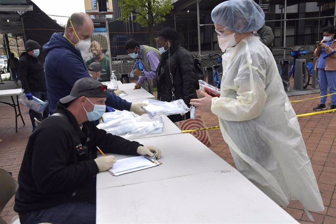 April 20, 2020 - New York, NY USA: A Bellevue Hospital staff nurse receives a personal protective package (PPE) on Monday, April 20, 2020 in New York City.