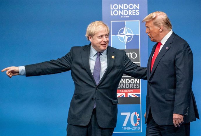 FILED - 04 December 2019, England, Watford: UK Prime Minister Boris Johnson (L), welcomes US President Donald Trump, prior to the start of a round table meeting during the annual NATO Leaders Summit at The Grove hotel. US President Donald Trump has cong