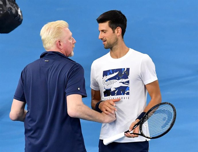 German ATP Cup captain Boris Becker (L) talks with Serbian tennis player Novak Djokovic during a training session at the Queensland Tennis Centre, ahead of the 2020 ATP Cup tennis tournament which will take place in Brisbane, Sydney and Perth